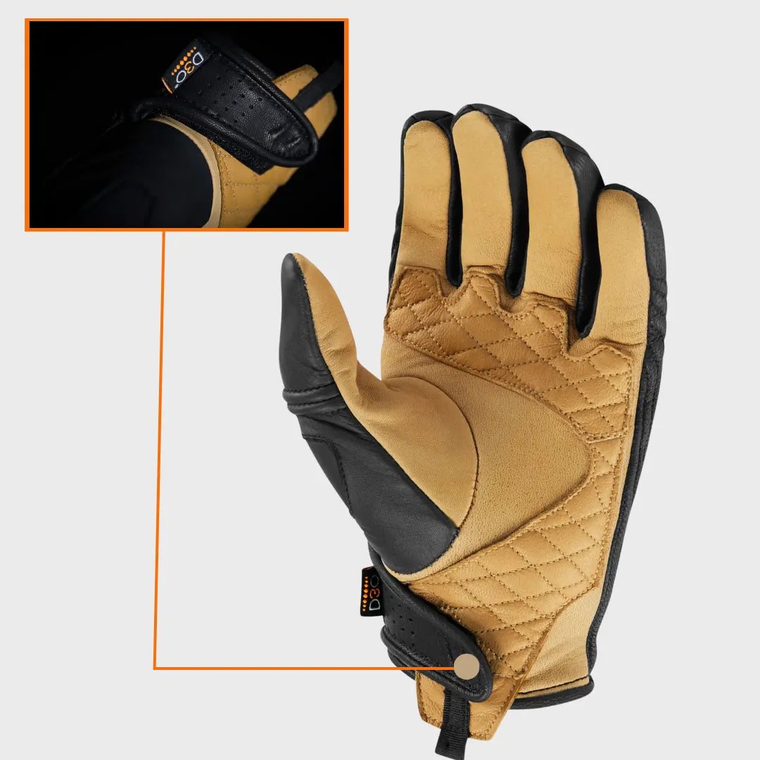 Rider wearing black and gold Icon Axys motorcycle gloves, showing fit and ergonomic design
