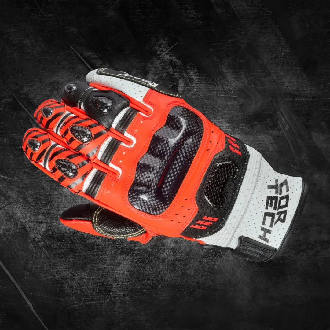 Arctiva Meridian men's Waterproof Snow Gloves A red and black motorcycle glove with carbon fiber knuckle protection on a textured dark background. The glove appears durable and high-tech.