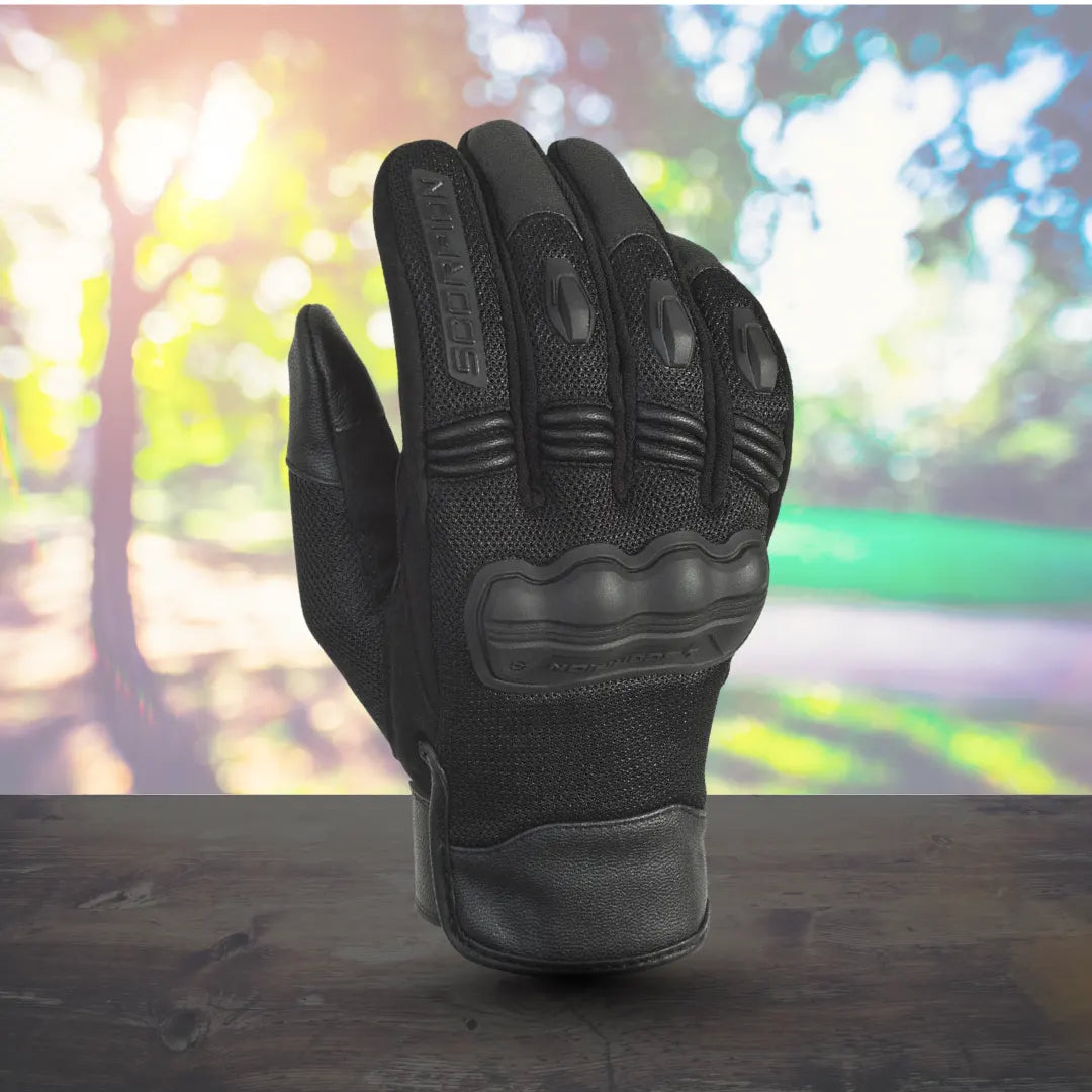 Black Scorpion Divergent motorcycle gloves with 3D molded knuckle and finger armor on a wooden surface