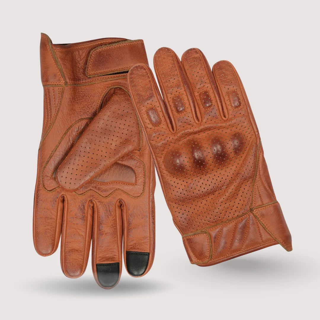 Close-up of premium brown leather perforated motorcycle gloves, highlighting the waxed leather finish and ventilation holes for improved airflow.