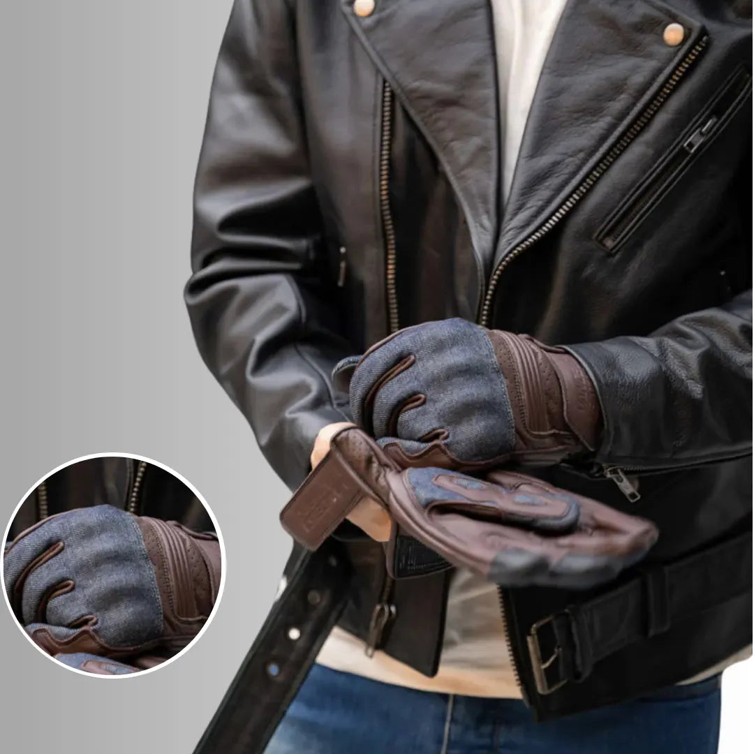 Person wearing a black leather jacket and gray gloves with a close-up of the gloves on a gray background