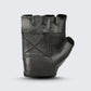Black leather fingerless motorcycle glove showing back stitches, elastic wrist strap, and durable top-grain leather construction for style and comfort.