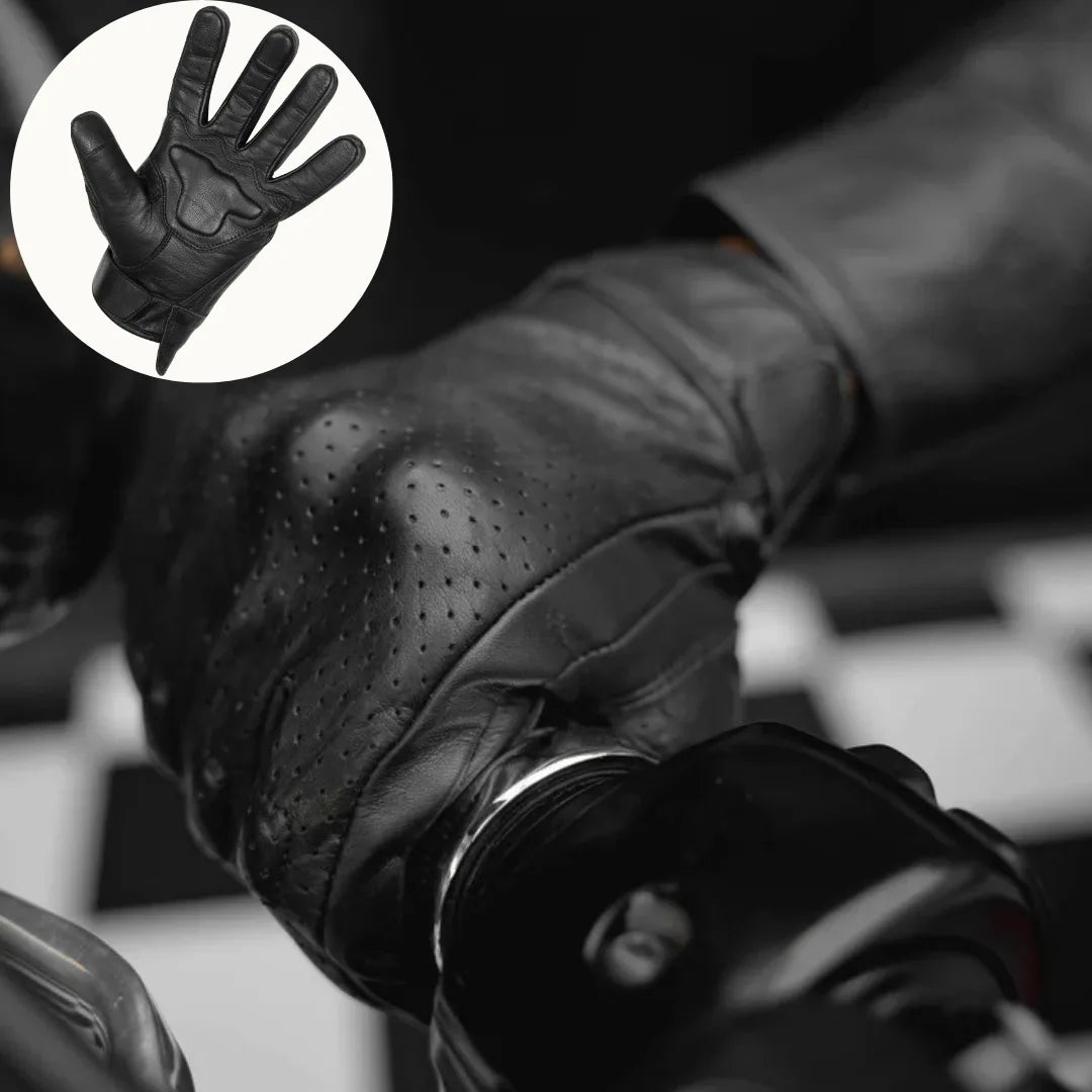 Close-up of black leather perforated motorcycle glove worn on hand, featuring touchscreen functionality for mobile use while riding